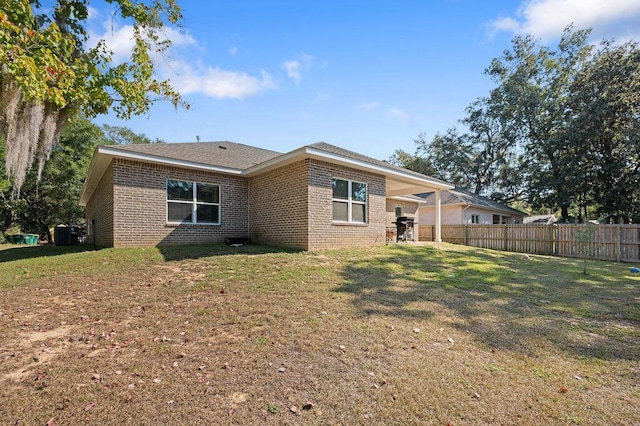 rear view of house with a yard