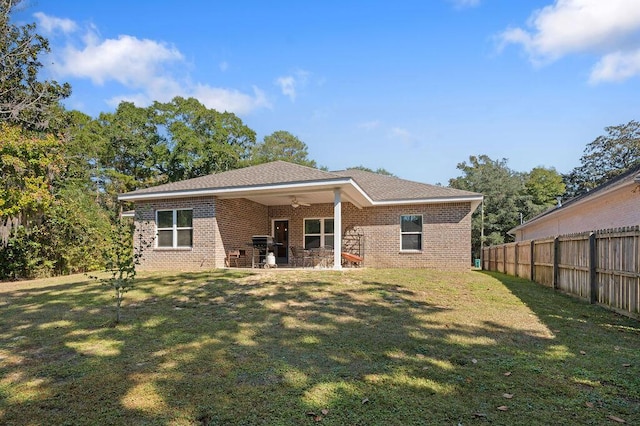 back of house with a patio area, ceiling fan, and a lawn