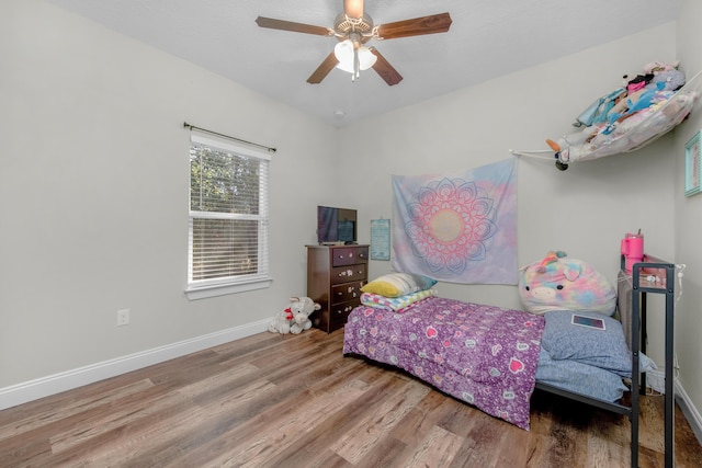 bedroom with ceiling fan and hardwood / wood-style floors