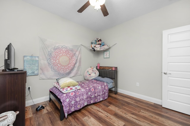 bedroom with ceiling fan and dark hardwood / wood-style floors