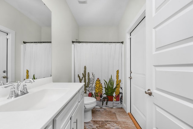 bathroom featuring toilet and vanity