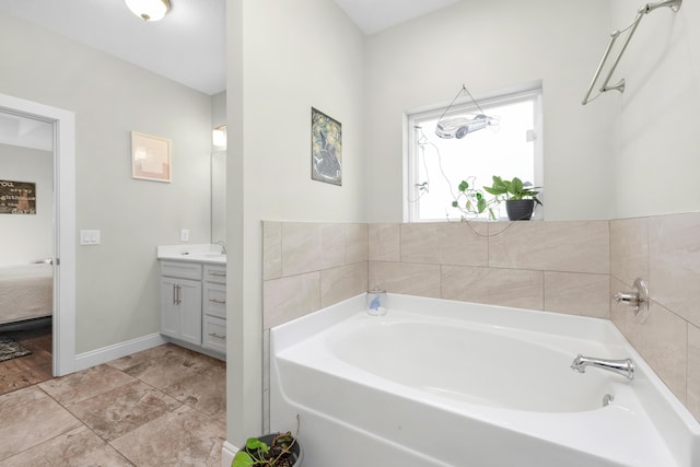 bathroom with vanity and a bath