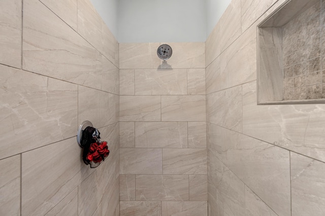 interior details with a tile shower