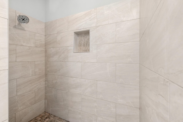 bathroom with a tile shower