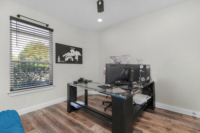 office with a healthy amount of sunlight and dark hardwood / wood-style floors