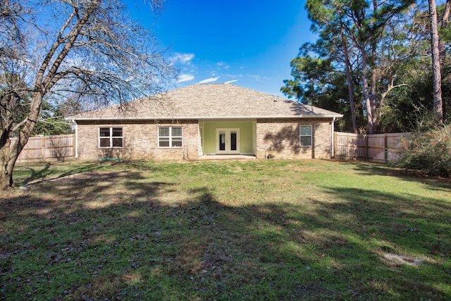 back of house featuring french doors and a yard