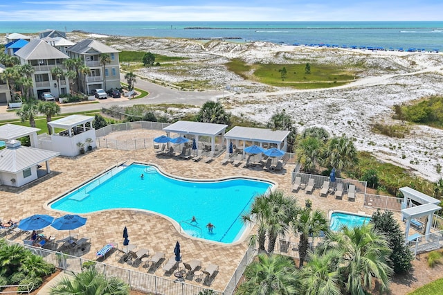 view of pool with a patio and a water view