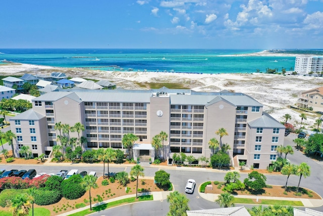 drone / aerial view with a beach view and a water view