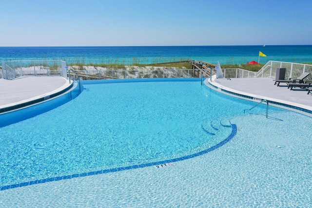 view of swimming pool featuring a water view