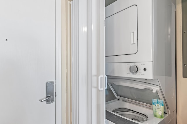 washroom featuring stacked washer / dryer