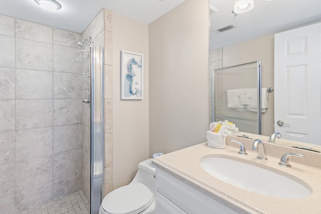 bathroom featuring walk in shower, vanity, and toilet