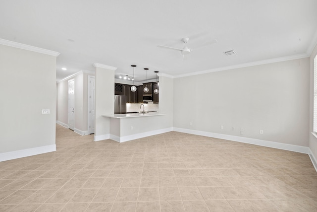 unfurnished living room with sink, crown molding, and ceiling fan