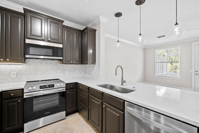 kitchen with stainless steel appliances, ornamental molding, sink, and pendant lighting