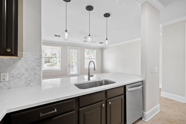 kitchen featuring pendant lighting, sink, crown molding, backsplash, and stainless steel dishwasher