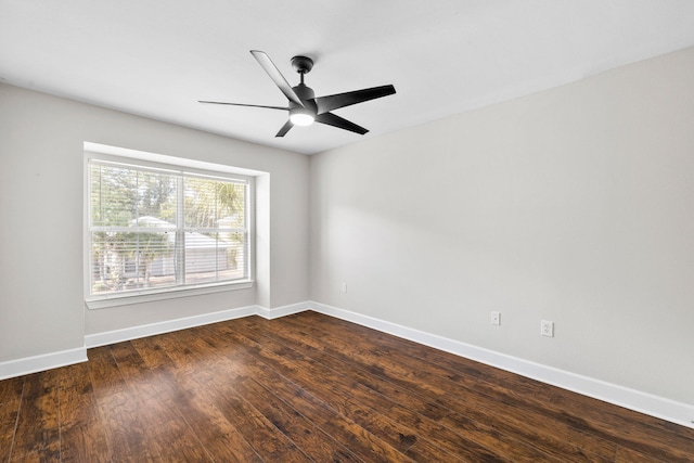 spare room with ceiling fan and dark hardwood / wood-style flooring