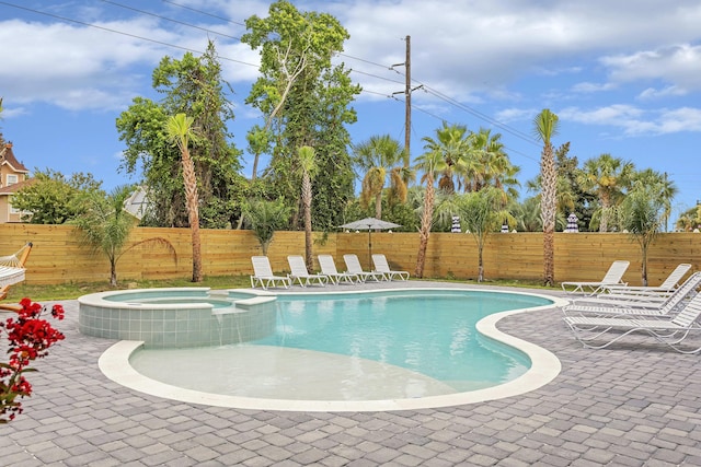 view of pool featuring an in ground hot tub and a patio