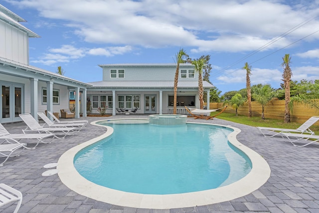 view of pool featuring a patio area and an in ground hot tub