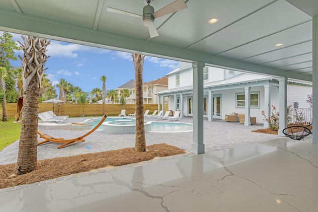 exterior space featuring a pool with hot tub and ceiling fan