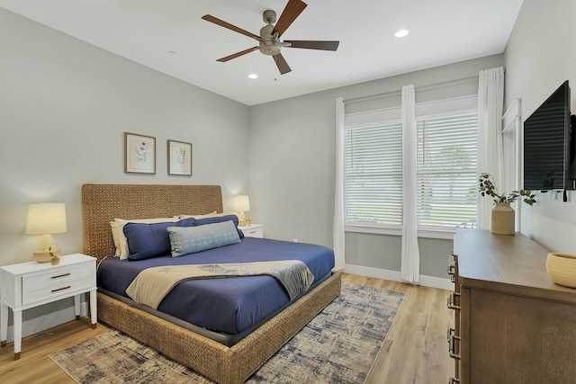 bedroom featuring ceiling fan and light hardwood / wood-style floors