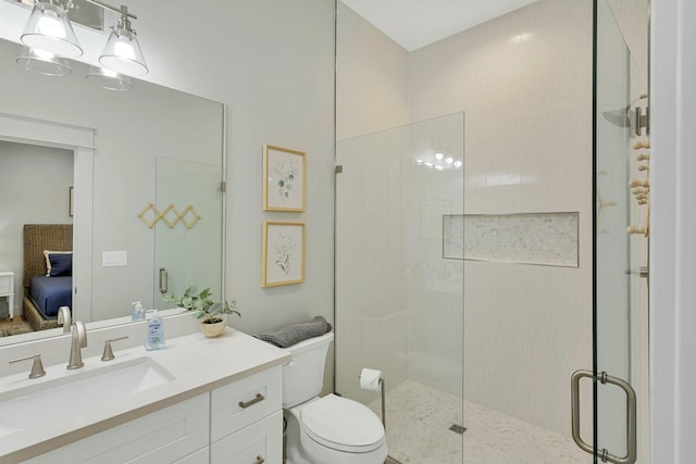 bathroom featuring toilet, a shower with shower door, and vanity