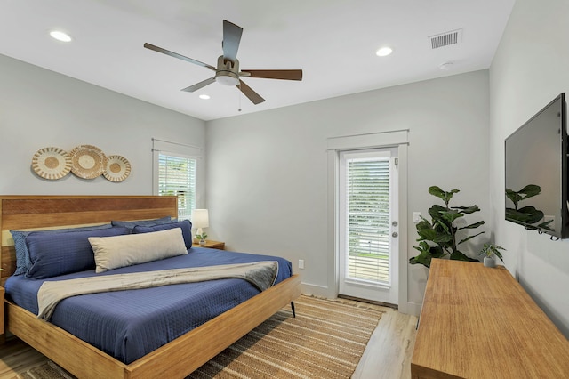 bedroom featuring multiple windows, ceiling fan, and light hardwood / wood-style floors