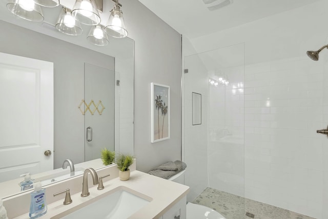 bathroom with an enclosed shower and vanity