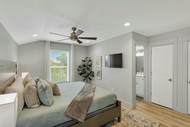 bedroom with connected bathroom, ceiling fan, vaulted ceiling, and light hardwood / wood-style flooring