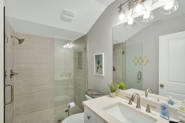 bathroom with toilet, a shower with door, vaulted ceiling, and vanity