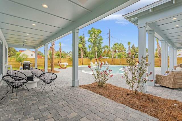 view of patio featuring a fenced in pool and area for grilling