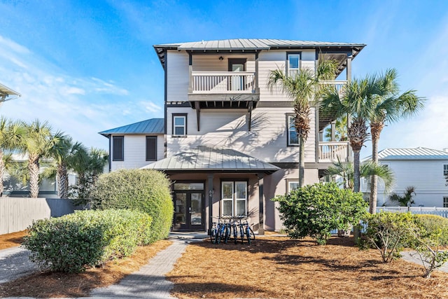 coastal home with a balcony and french doors