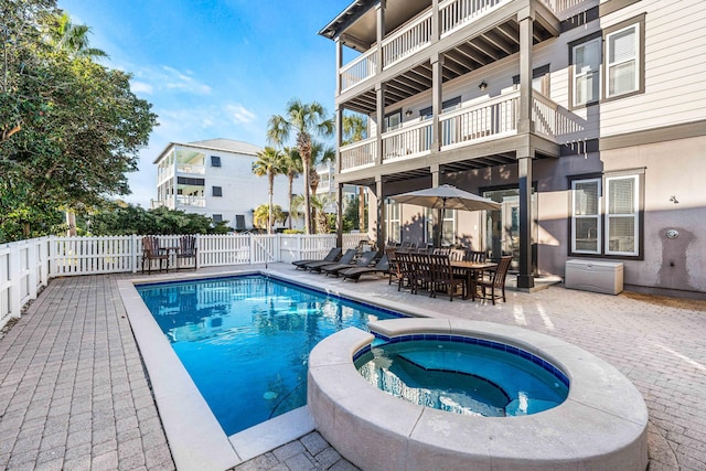 view of pool with an in ground hot tub and a patio area