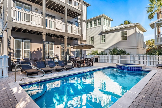 view of swimming pool with a patio area and an in ground hot tub