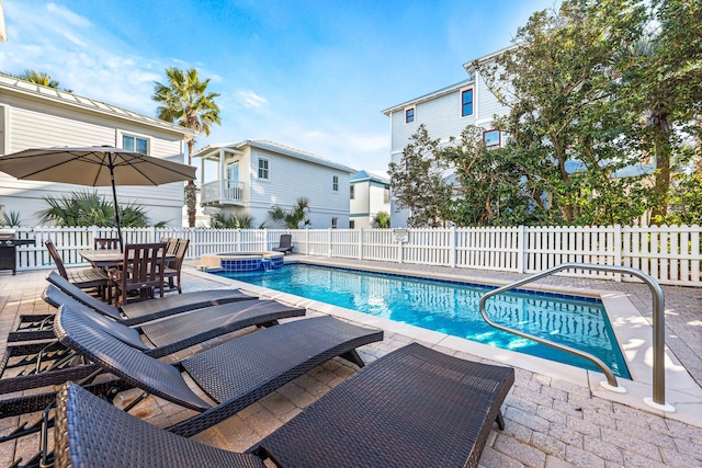 view of pool with an in ground hot tub and a patio area