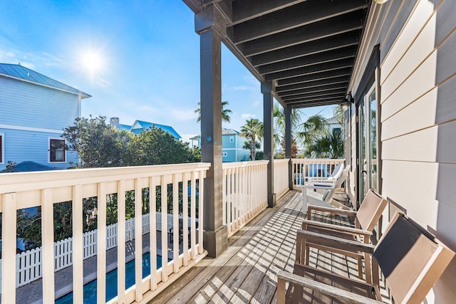 wooden terrace with a pool