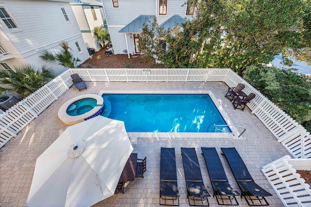 view of pool with an in ground hot tub and a patio area