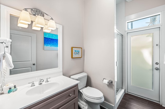 bathroom featuring vanity, hardwood / wood-style floors, toilet, and walk in shower