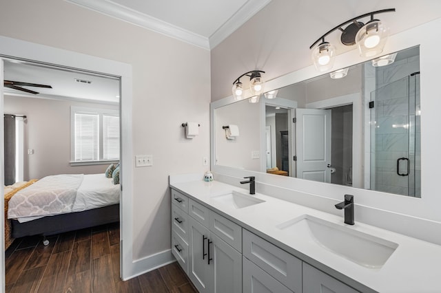 bathroom with vanity, hardwood / wood-style floors, crown molding, and a shower with door