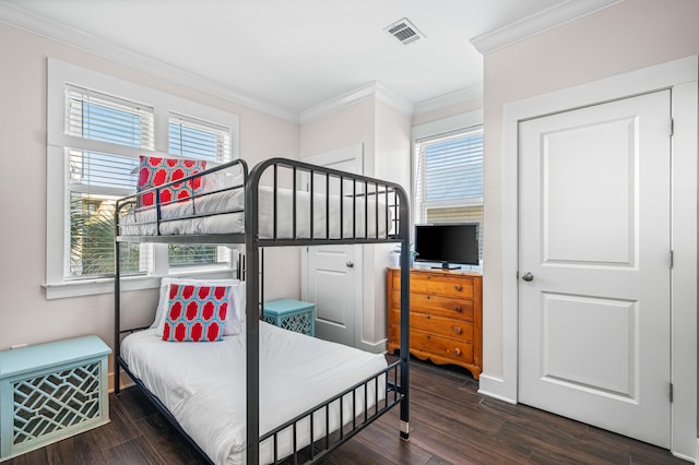 bedroom featuring dark hardwood / wood-style flooring and crown molding