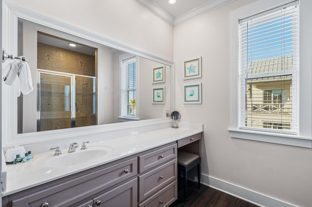 bathroom with an enclosed shower, vanity, crown molding, and a healthy amount of sunlight