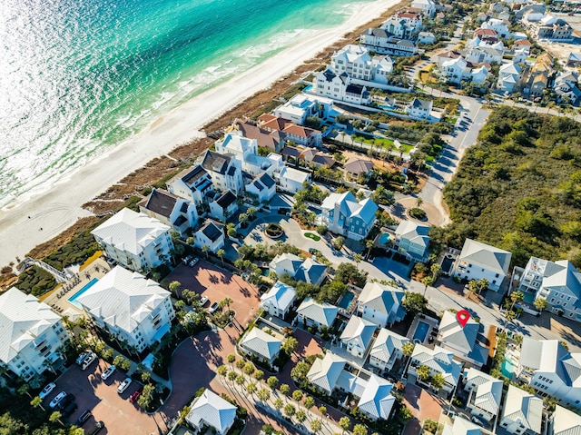 bird's eye view featuring a water view and a beach view