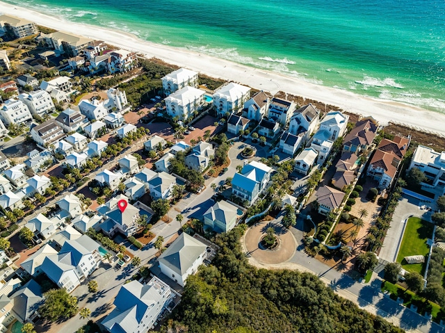 drone / aerial view with a water view and a beach view