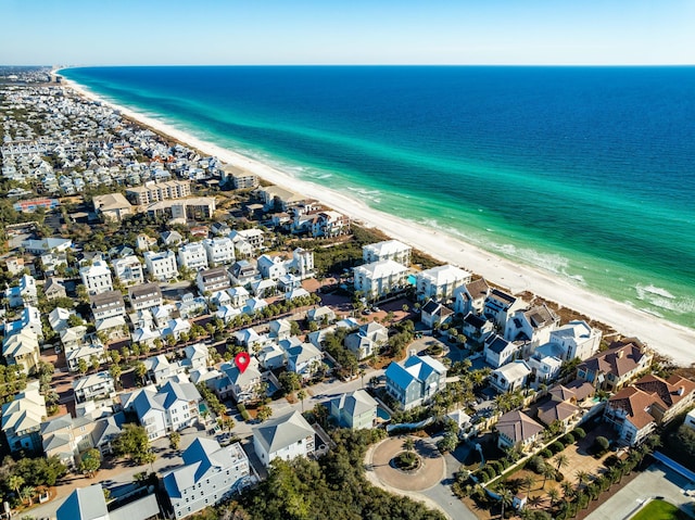 drone / aerial view with a beach view and a water view