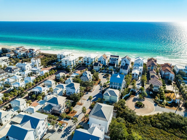 aerial view with a water view and a beach view