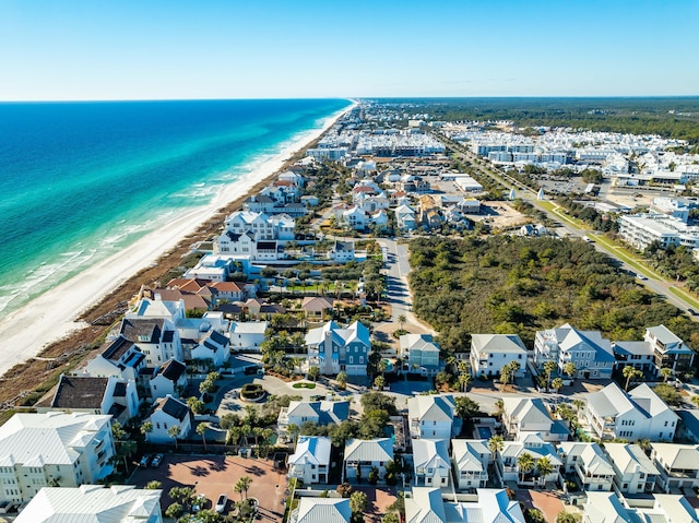 bird's eye view featuring a water view and a beach view