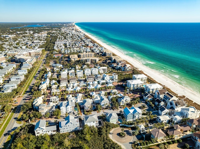 birds eye view of property with a water view and a beach view