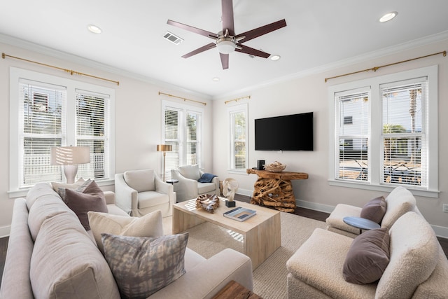 living room featuring hardwood / wood-style flooring, plenty of natural light, and ornamental molding