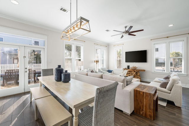 dining area with dark hardwood / wood-style flooring, crown molding, french doors, and ceiling fan