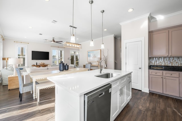 kitchen featuring sink, white cabinetry, an island with sink, decorative light fixtures, and stainless steel dishwasher