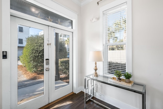 doorway to outside with dark hardwood / wood-style flooring, ornamental molding, and french doors