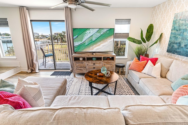 living room featuring ceiling fan and light hardwood / wood-style flooring